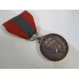 A World War Two (WWII) Imperial Service Medal inscribed Thomas Mitchell, with ribbon.