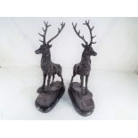 A pair of hot cast bronze stags on a marble plinth, signed, approximate height 45 cm.