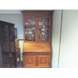 An inlaid bureau bookcase with two drawer over two door cupboard with astral glazed display