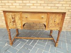 A carved oak dressing table,