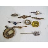 A quantity of vintage brooches and stick pins to include some silver,