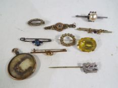 A quantity of vintage brooches and stick pins to include some silver,