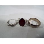 Three silver dress rings.