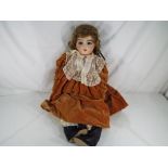 Dolls - A reproduction Bru Jne bisque headed doll with fixed blue glass eyes, pierced ears,