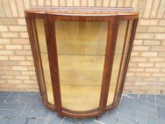 A glass bow fronted display cabinet, approximate height 116 cm x 106 cm x 40 cm.