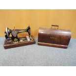A tabletop Singer sewing machine with hard case, serial number Y7732435,