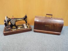 A tabletop Singer sewing machine with hard case, serial number Y7732435,