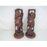 Two highly carved treen Japanese figures on plinths