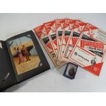 An early 20th century album containing approximately 36 pictorial postcards of the period to