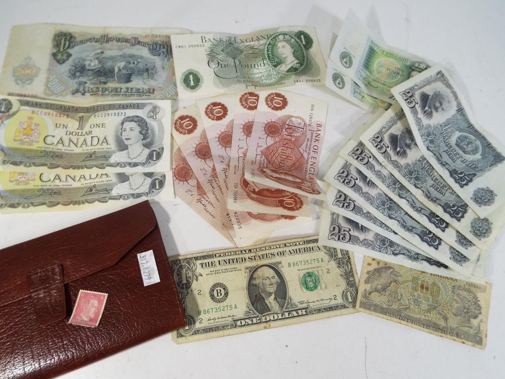 Notaphily - a leather wallet containing a small quantity of UK and world banknotes
