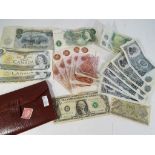 Notaphily - a leather wallet containing a small quantity of UK and world banknotes