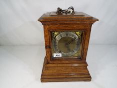 An good oak cased quarter striking ting-tang library mantel clock by the German factory of