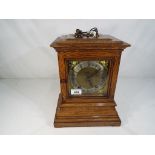 An good oak cased quarter striking ting-tang library mantel clock by the German factory of