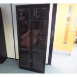 A modern black wooden twin-door display cabinet with glass shelved interior,