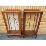 A matching pair of glass fronted display cabinets approximate height 150 cm x 56 cm x 30 cm.