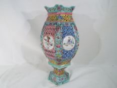 A Chinese reticulated porcelain hexagonal form lantern with matching stand,