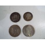 Four UK pre-decimal coins comprising a Victorian double florin (4/-) dated 1890,