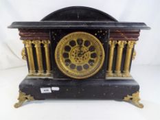 A wood cased mantel clock with Arabic numerals to the pierced dial by Gilbert Clock Company,