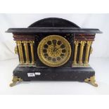 A wood cased mantel clock with Arabic numerals to the pierced dial by Gilbert Clock Company,