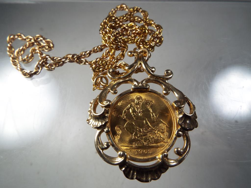A gold sovereign marked 1963 set in 9ct gold mount on 9ct gold rope chain, total weight approx 22.
