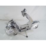 A chrome scooter with stand.