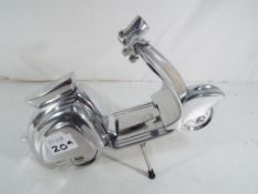 A chrome scooter with stand.