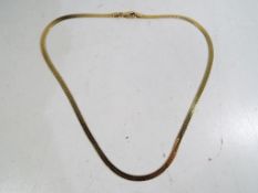 A yellow metal necklace stamped .