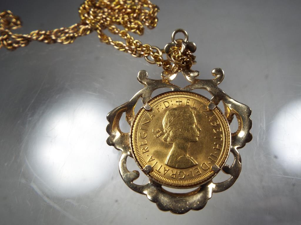 A gold sovereign marked 1963 set in 9ct gold mount on 9ct gold rope chain, total weight approx 22. - Image 2 of 2