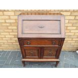 A drop fronted bureau over a cupboard and one drawer, approximate height 102 cm x 70 cm x 47 cm.