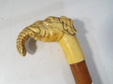A 19th century walking stick with carved ivory handle in the form of an elephant with a horn