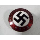 A enamelled pin badge marked Adolf Hitler 1933, verso Gesgesch and RZM logo,