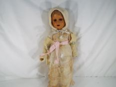 An early period doll acquired from Singapore in 1946, sleeping eyes, open mouth with upper teeth,