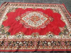 A large traditional rug / carpet with a floral design on a burgundy ground,