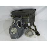 A Polish M10 gas mask with filters and fabric carry bag.