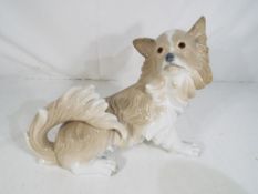 Lladro - a large Lladro figurine of a dog entitled Papillon model #4857 stamped insized marks to