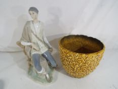 A Lladro figurine depicting a man seated on a tree stump and a Sylvac jardiniere inscribed with