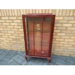 A glass fronted display cabinet containing two glass shelves,