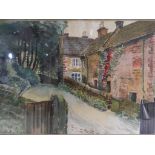 A watercolour, mounted and framed under glass depicting a cottage on a country lane,