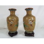 A pair of cloisonne vases with floral and foliate decoration on wooden stand approx 20.
