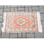A good quality silk rug with traditional decoration,