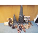 A large collection of tribal wooden carvings and items.