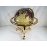 A large gemstone terrestrial globe on gilt metal frame support,