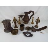 A collection of bronze and metal items to include a rare oil lamp and a pair of gilt bronze figures.