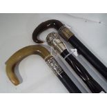 A walking stick with a horn handle and a silver hallmarked collar (hallmark rubbed) inscribed April