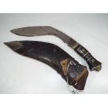 A Nepalese style kukri knife with inlaid handle and pattered blade,