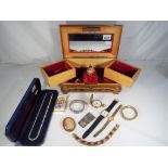 A good quality jewellery box containing a small quantity of costume jewellery and watches to