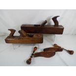 Two vintage woodworking planes and a pair of boot scratchers