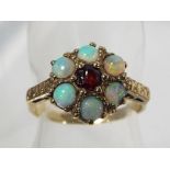 A lady's 9 carat gold opal and ruby ring, size A and a half, approximate weight 2.19 grams.