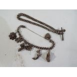 A lady's silver charm bracelet containing six charms,