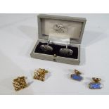 A gentleman's pair of hallmarked 9 carat gold cufflinks in open work pattern with satin and bark